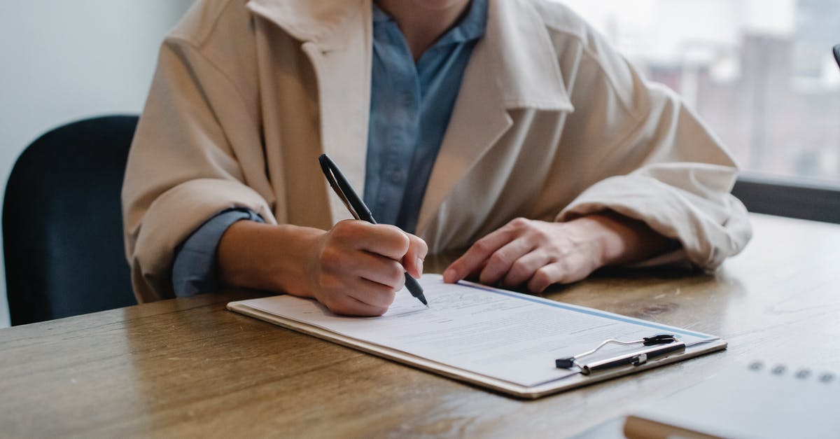 Factorio: How to fill belts on-demand? - Focused woman writing in clipboard while hiring candidate