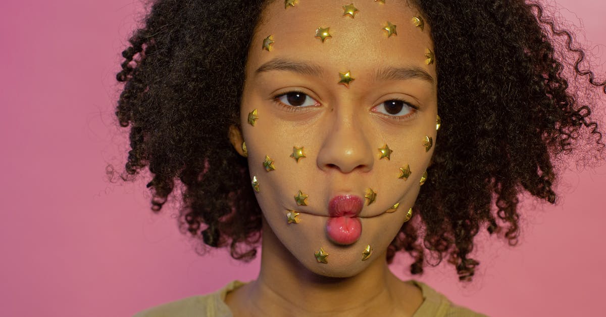Failed to reach to yellow star icon - Young African American female with yellow star rhinestones on face looking at camera while making fish lips on pink background Failed to reach to yellow star icon - Young African American female with yellow star rhinestones on face looking at camera while making fish lips on pink background