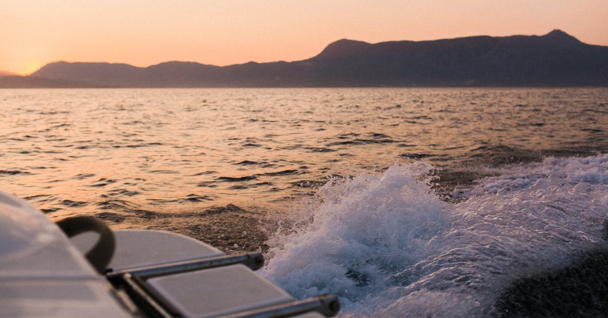 Fallout 4 - Freedom Trail Code - Trail of white splashing water after motorboat on water surface against mountains in dusk Fallout 4 - Freedom Trail Code - Trail of white splashing water after motorboat on water surface against mountains in dusk