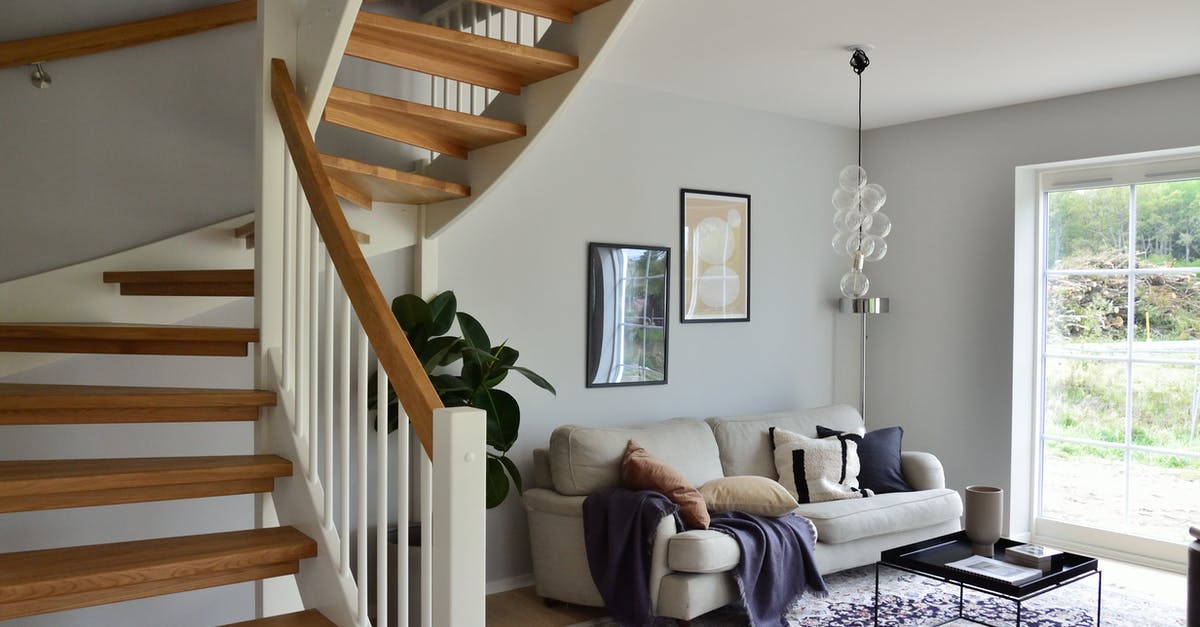 Fallout shelter Broadcast Center - White Sofa Beside Brown Wooden Staircase