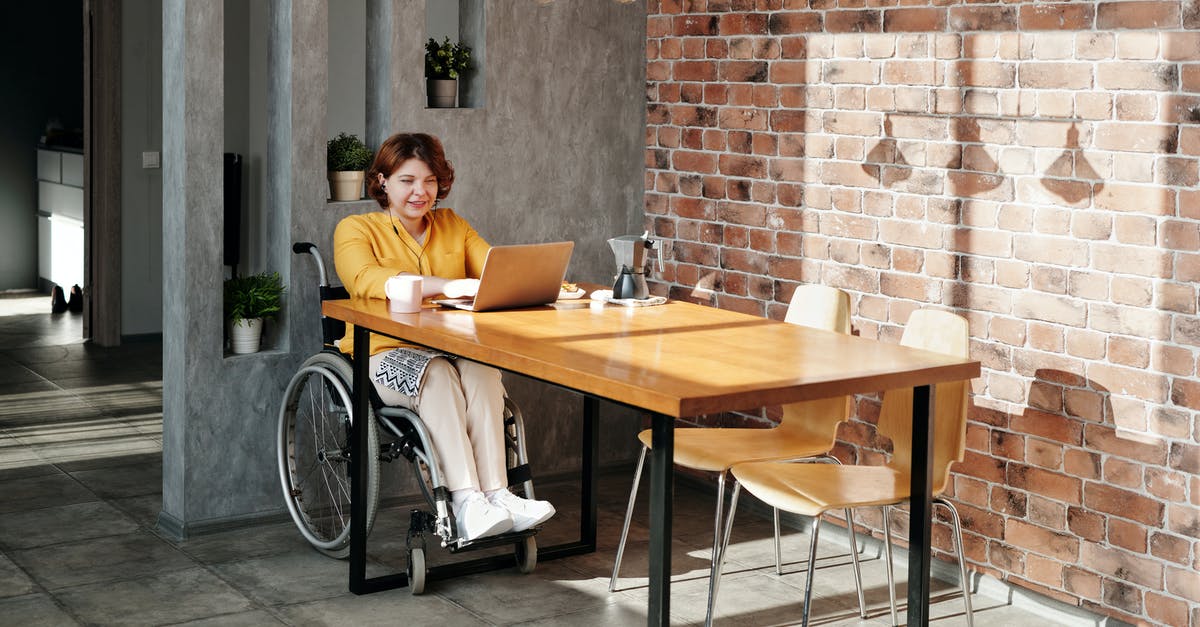 Fallout Shelter Dweller Happiness [duplicate] - Woman Sitting on Wheelchair While Using Laptop