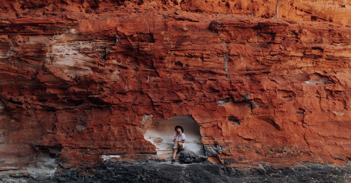 Fallout Shelter Exploring the Wastland - Woman in White Shirt Sitting on Rock Formation Fallout Shelter Exploring the Wastland - Woman in White Shirt Sitting on Rock Formation