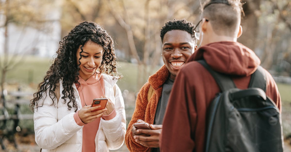 Far Cry 3 Online Multiplayer Never Finds Other Players - Happy multiethnic friends with smartphones on street