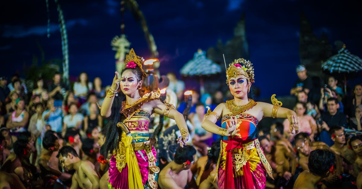 Festival of Time Secrets - Two Women Dancing While Wearing Dresses at Night Time