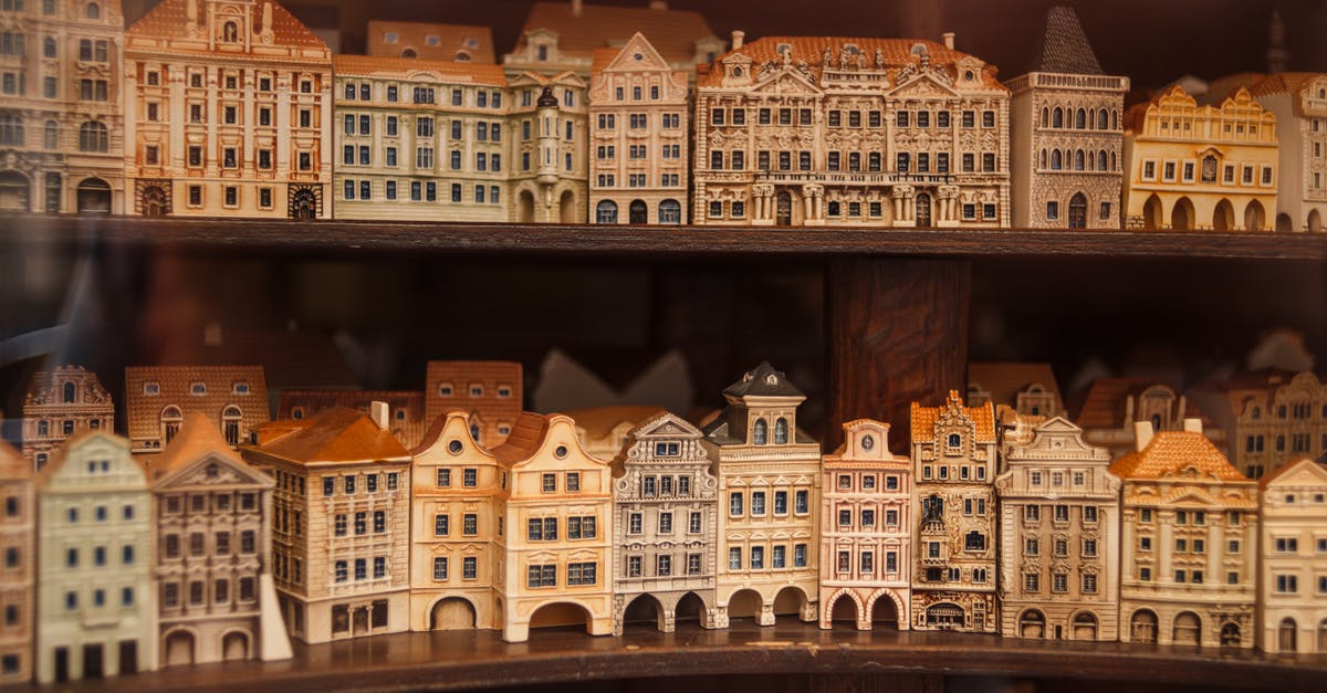 FFXIV window size - Through glass wall view of small building models with chimneys on roofs and arched doors on wooden shelves FFXIV window size - Through glass wall view of small building models with chimneys on roofs and arched doors on wooden shelves