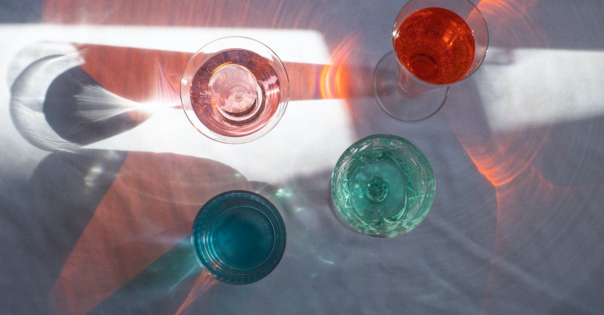 Fill in red boxes - Top view of transparent glasses filled with different beverages and placed at sun beam