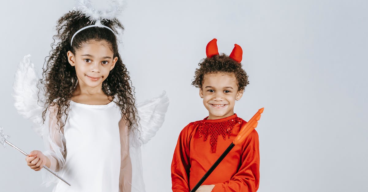 Final Fantasy - Different countries, timelines, or universes? - Cute little black children in angel and devil costumes smiling at camera in white studio Final Fantasy - Different countries, timelines, or universes? - Cute little black children in angel and devil costumes smiling at camera in white studio