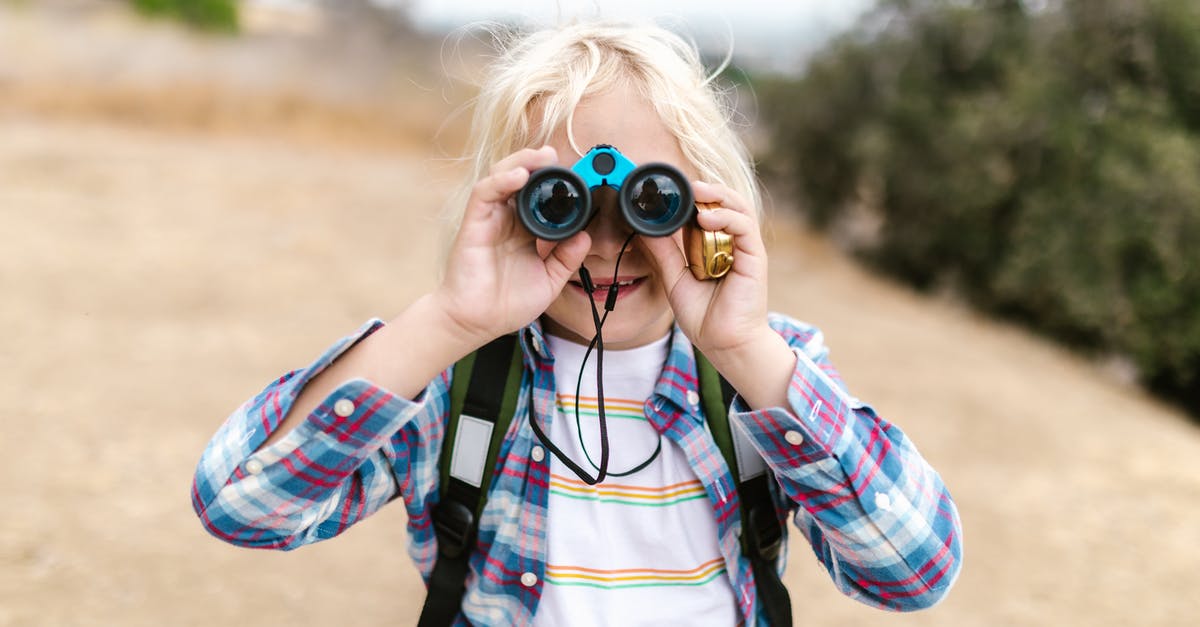First adventure for a beginner - Woman in Blue White and Red Plaid Dress Shirt Using Binoculars