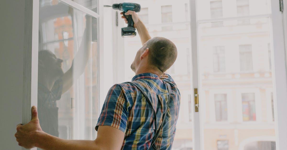 Fix or reinstall DirectX in Windows 8 - Back view of worker in checkered shirt drilling window frame during renovation process in apartment Fix or reinstall DirectX in Windows 8 - Back view of worker in checkered shirt drilling window frame during renovation process in apartment