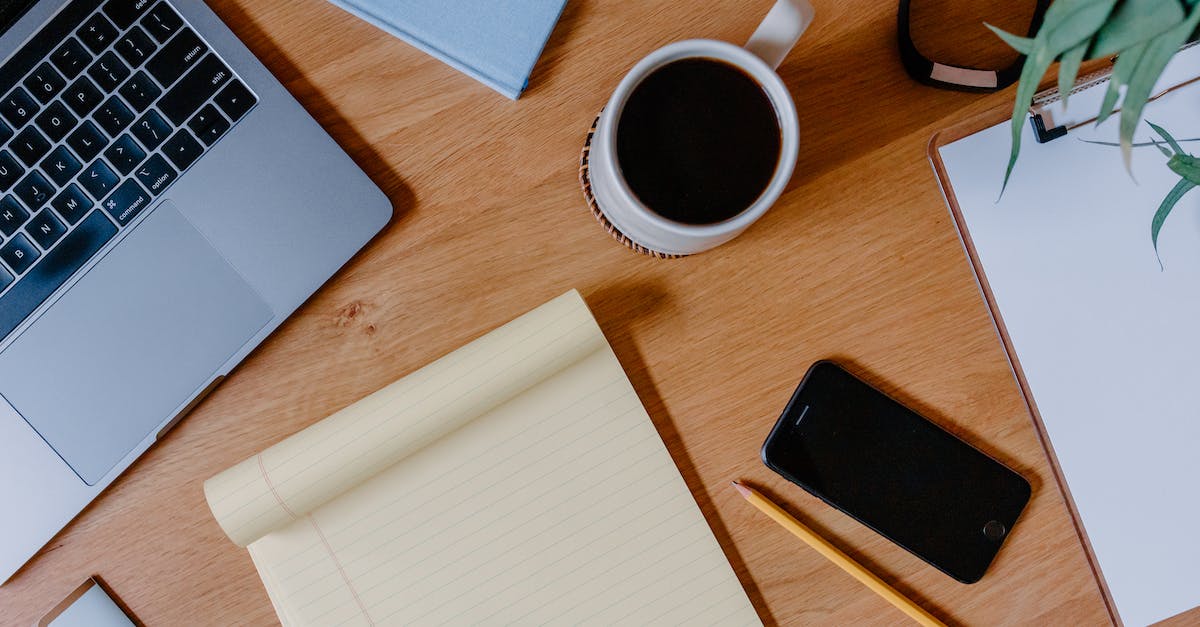 Fix to not being able to press Up+Down on PS3 Konami Dance Pad on PC - Black Coffee and Cellphone Beside Yellow Paper on Brown Wooden Table