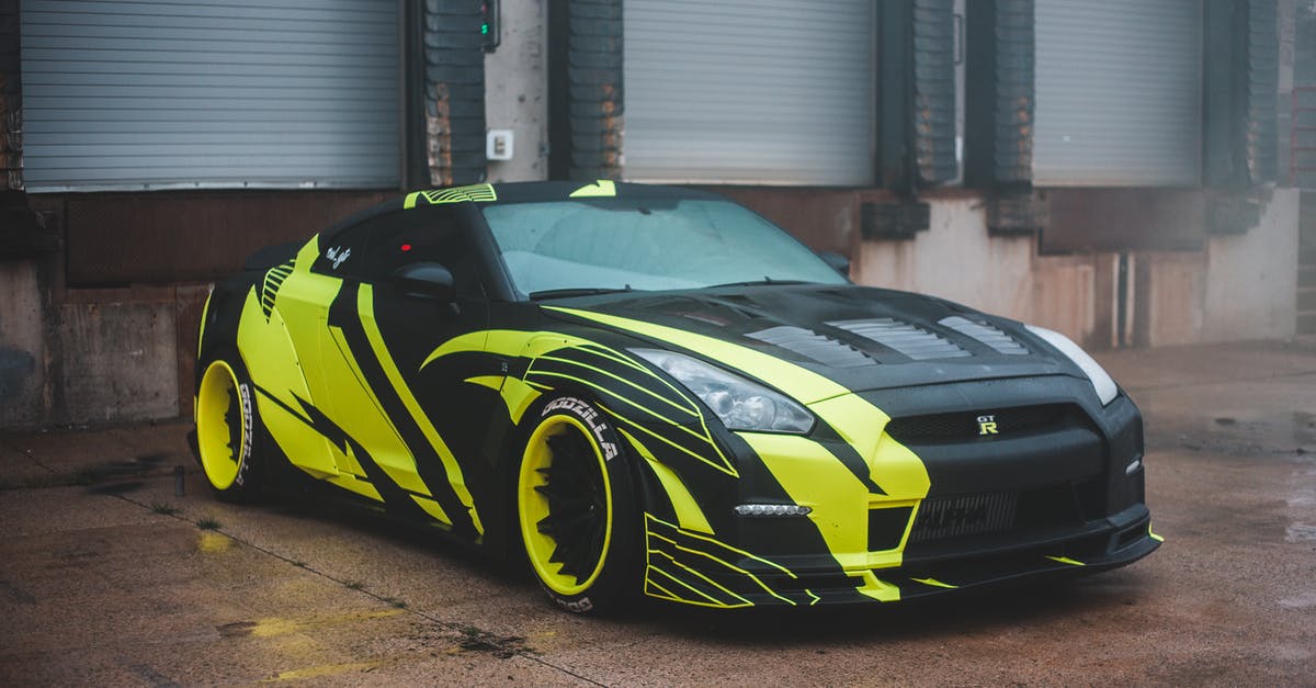 Fixing the disc reader on an SCPH-30001 NTSC-U/C model PlayStation 2 - Luxury sports car with yellow wrapping decal design parked on pavement near industrial building with closed blinds in city on street