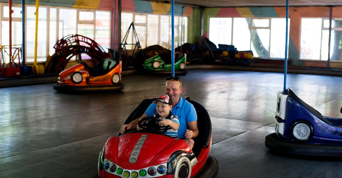 Flexibility of truck's steering wheel with keyboard - Man and Boy Riding Bumper Car