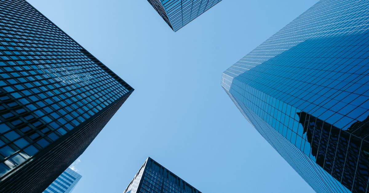 Follower bug: can't progress - Low angle of high business towers with glass mirrored windows located in megalopolis downtown against blue sky Follower bug: can't progress - Low angle of high business towers with glass mirrored windows located in megalopolis downtown against blue sky