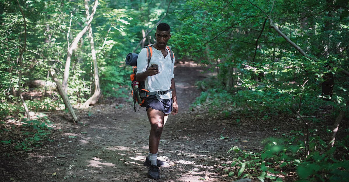 Follower lost custom equipment after wedding - African American man with backpack in forest Follower lost custom equipment after wedding - African American man with backpack in forest