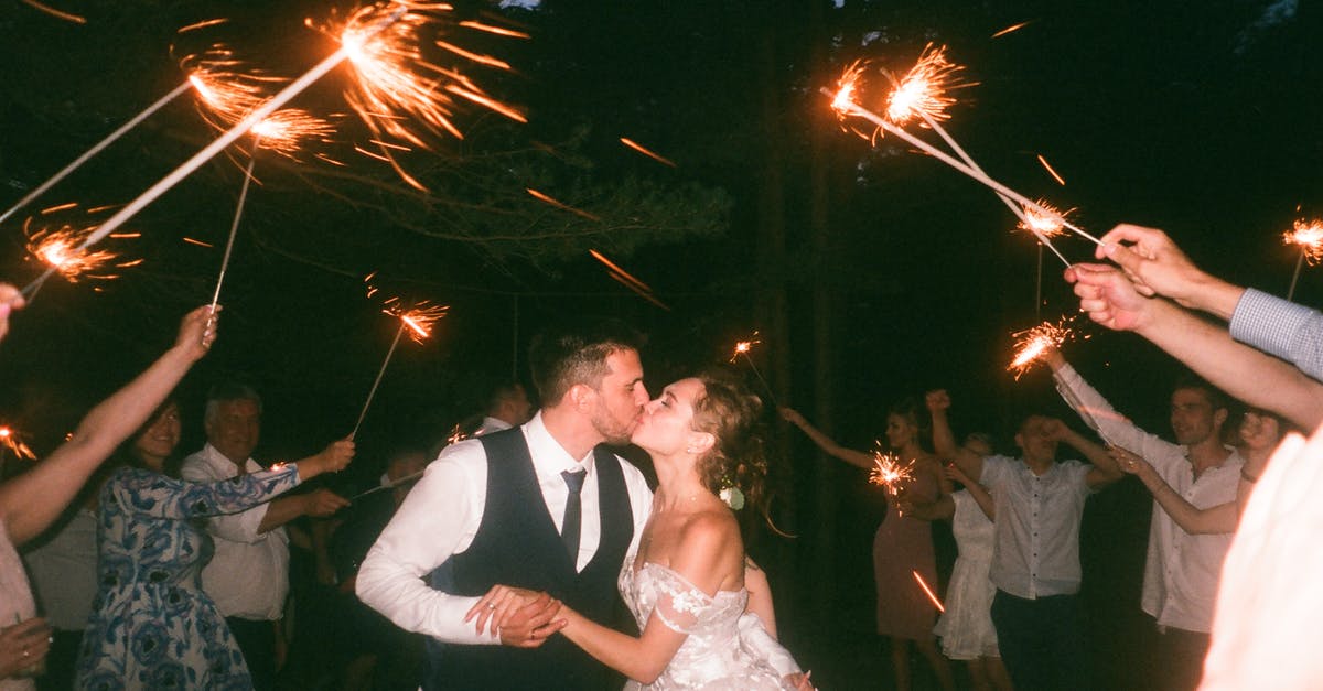 For the dancing couples objective, does it have to be unique couples? - People Raising Lit Sparklers While Encircling Bride and Groom Kissing