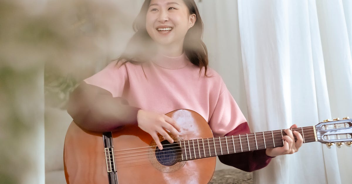 Force a Player out of bed on a certain night? - Smiling Asian woman with guitar Force a Player out of bed on a certain night? - Smiling Asian woman with guitar