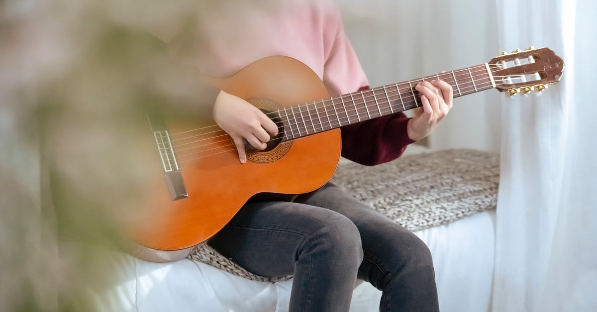 Force a Player out of bed on a certain night? - Crop woman playing guitar at bedroom with flowers Force a Player out of bed on a certain night? - Crop woman playing guitar at bedroom with flowers