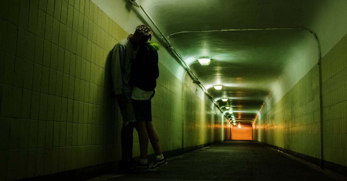 Forcing a faction to revolt - Man in Black Jacket and Black Shorts Walking on Hallway Forcing a faction to revolt - Man in Black Jacket and Black Shorts Walking on Hallway