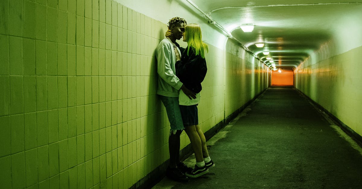 Forcing a faction to revolt - Man in Green Jacket and Black Pants Walking on Hallway Forcing a faction to revolt - Man in Green Jacket and Black Pants Walking on Hallway