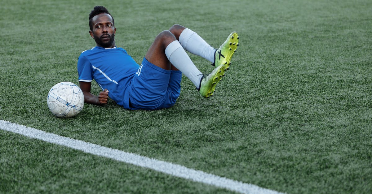Forgot Player ID for Pokemon.com - Man in Blue T-shirt and Yellow Shorts Sitting on Green Grass Field
