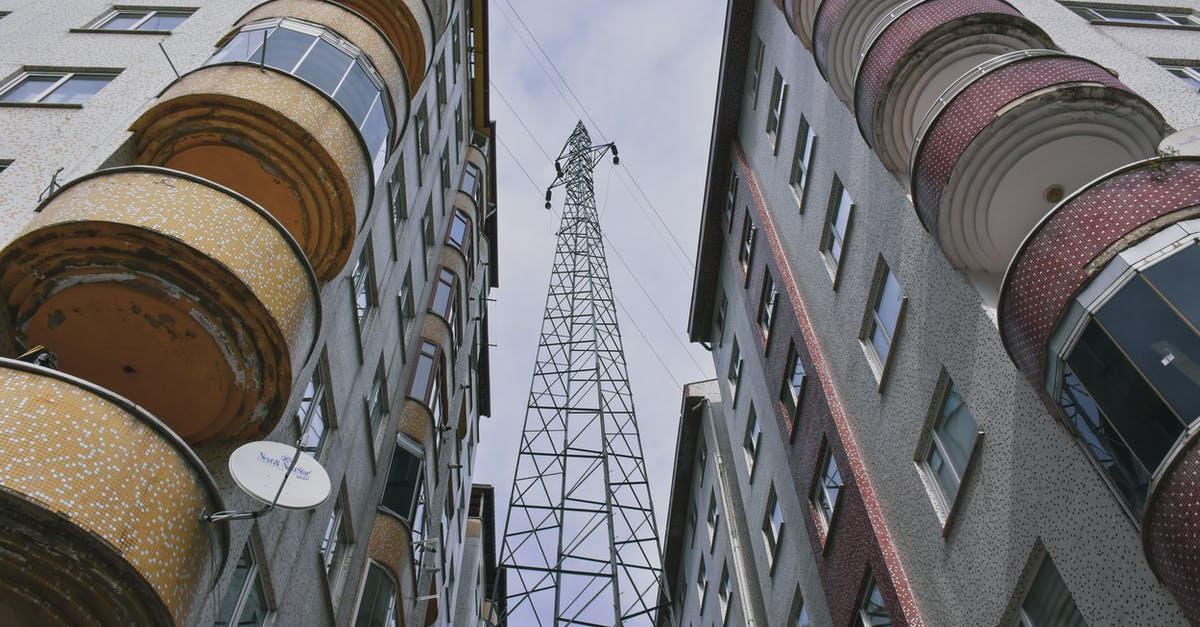 Foundation issue between buildings - Low Angle Shot of a Electric Tower Between Building