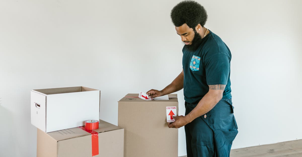Fragile cutscene - Man in Blue Crew Neck T-shirt and Blue Denim Jeans Holding White Box Fragile cutscene - Man in Blue Crew Neck T-shirt and Blue Denim Jeans Holding White Box