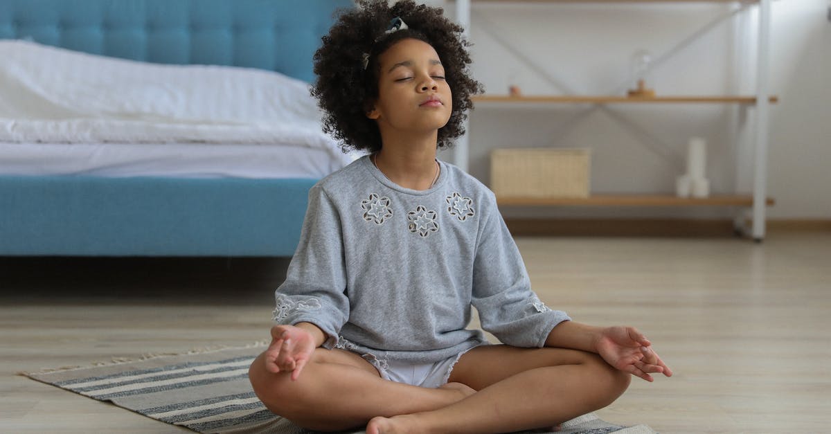Free Spirit Ending on Chipset-0 - Full body of African American child with curly hair in casual clothing meditating with eyes closed and legs crossed Free Spirit Ending on Chipset-0 - Full body of African American child with curly hair in casual clothing meditating with eyes closed and legs crossed