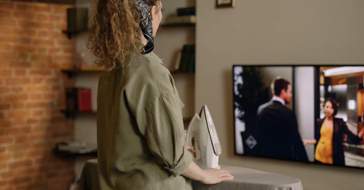 Full Screen Keep Resolution - Woman in Brown Coat and Blue Denim Jeans Standing Near Table Full Screen Keep Resolution - Woman in Brown Coat and Blue Denim Jeans Standing Near Table