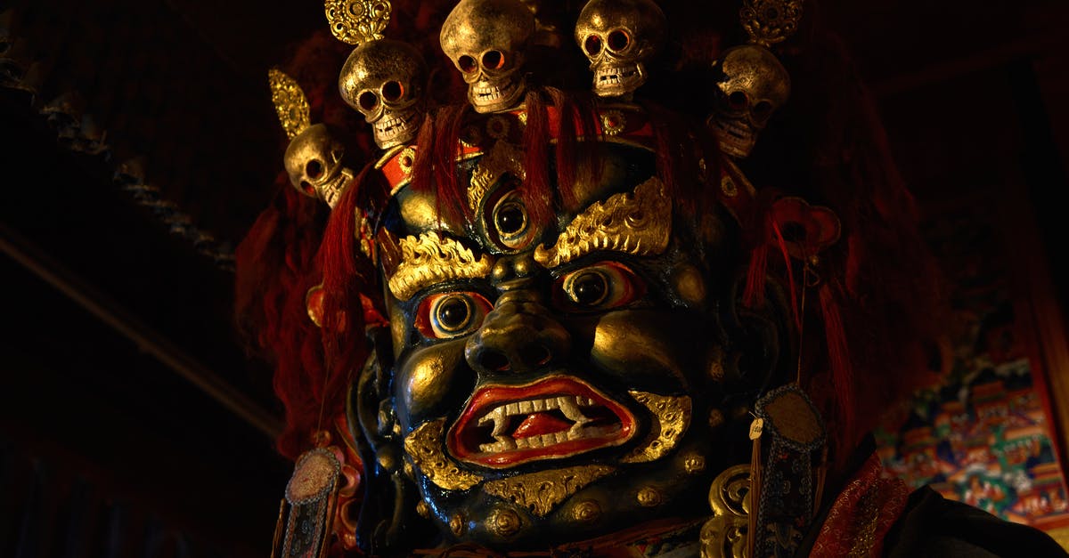 Function not looping [mcfunction] - From below of Tsam mystery mask with gilded human face and third eye and pig nose and fangs among teeth and golden circles around face and full head of red hair decorated with red hairband adorned with golden skulls