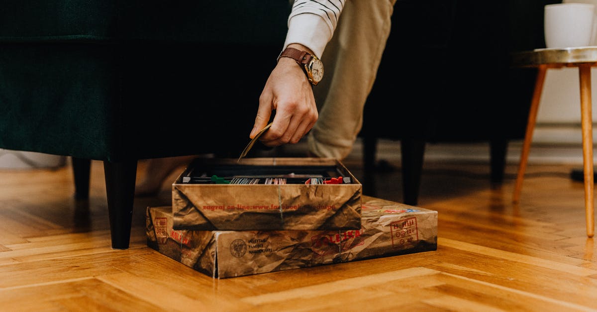 Game emulation legally [closed] - Person in White Long Sleeve Shirt Holding Brown and Red Box