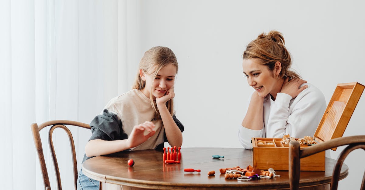 Game saves on emulators - Mother and Daughter Playing at a Table Game saves on emulators - Mother and Daughter Playing at a Table