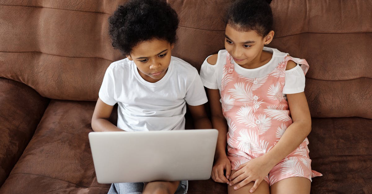 Game streaming is turned off on your Xbox One message appears even though streaming is enabled - Siblings Sitting on a Couch and Looking at a Laptop