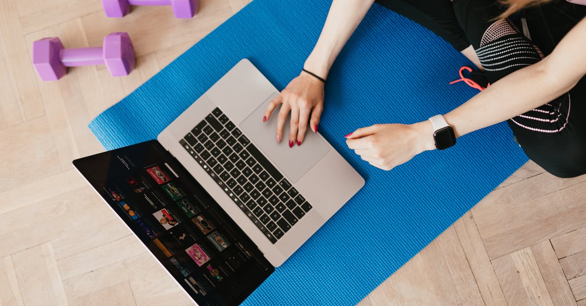 Games don't fit in screen when launched in full screen mode (show only left-top quarter) - Top view of crop female in activewear sitting on yoga mat on floor and using laptop Games don't fit in screen when launched in full screen mode (show only left-top quarter) - Top view of crop female in activewear sitting on yoga mat on floor and using laptop