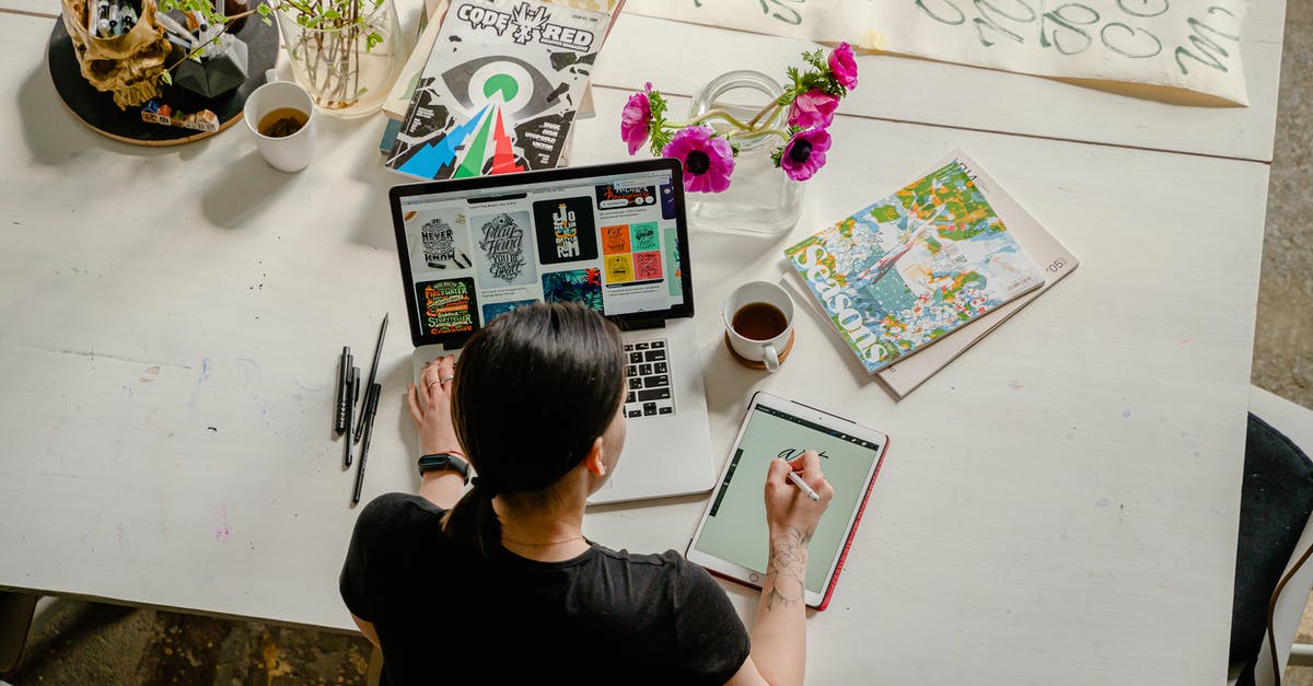 Garbled Graphics NES - Photo of Woman Writing on Tablet Computer While Using Laptop