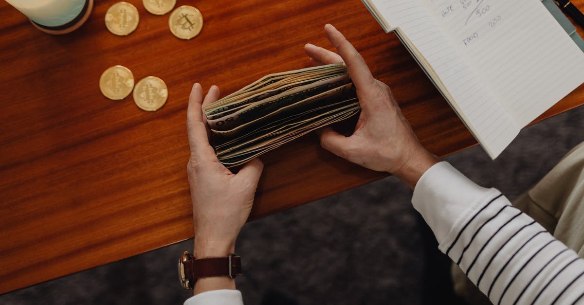 Gave Money to Wrong Person in Mission - Person Counting Bills and Bitcoins on Table Gave Money to Wrong Person in Mission - Person Counting Bills and Bitcoins on Table