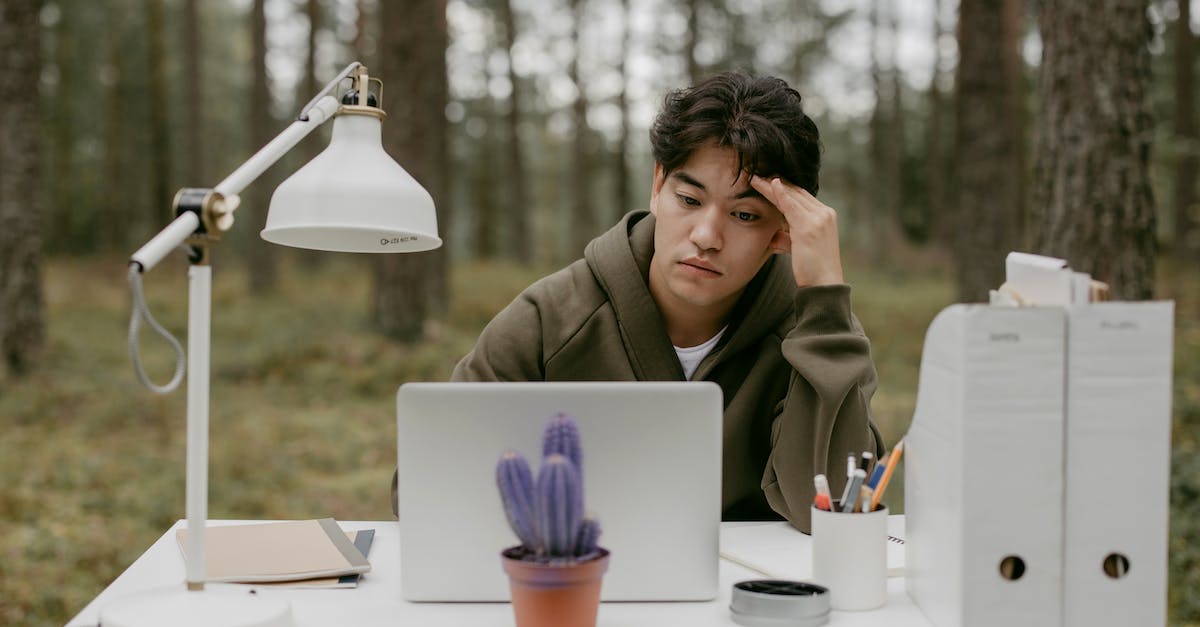 GBA SP screen suddenly turning darker for no reason - Woman in Brown Coat Sitting by the Table With Macbook