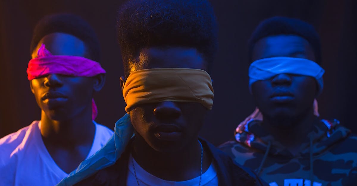 Generation 1 trading? - Anonymous cool ethnic male band with Afro hairstyle and covered eyes illuminated by artificial light