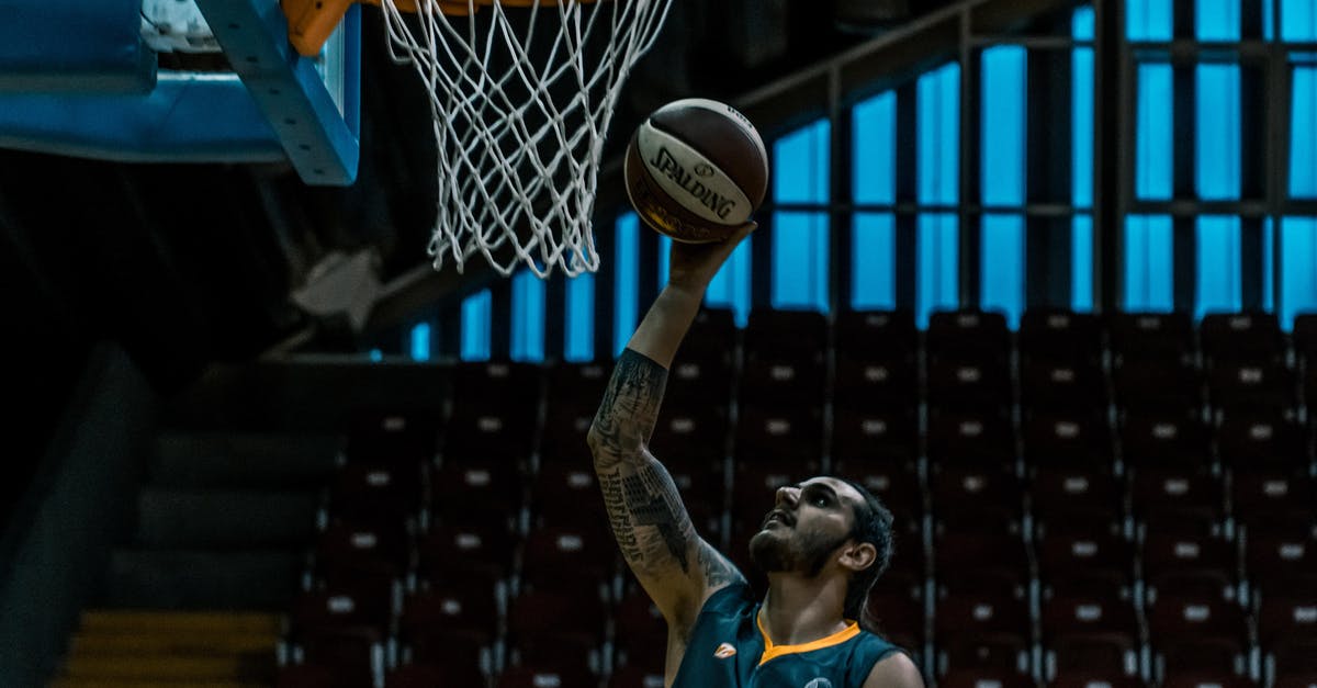 Get the player with the highest score on the scoreboard - Man Holding White and Black Spalding Basketball Near Brown and White Basketball Hoop Get the player with the highest score on the scoreboard - Man Holding White and Black Spalding Basketball Near Brown and White Basketball Hoop