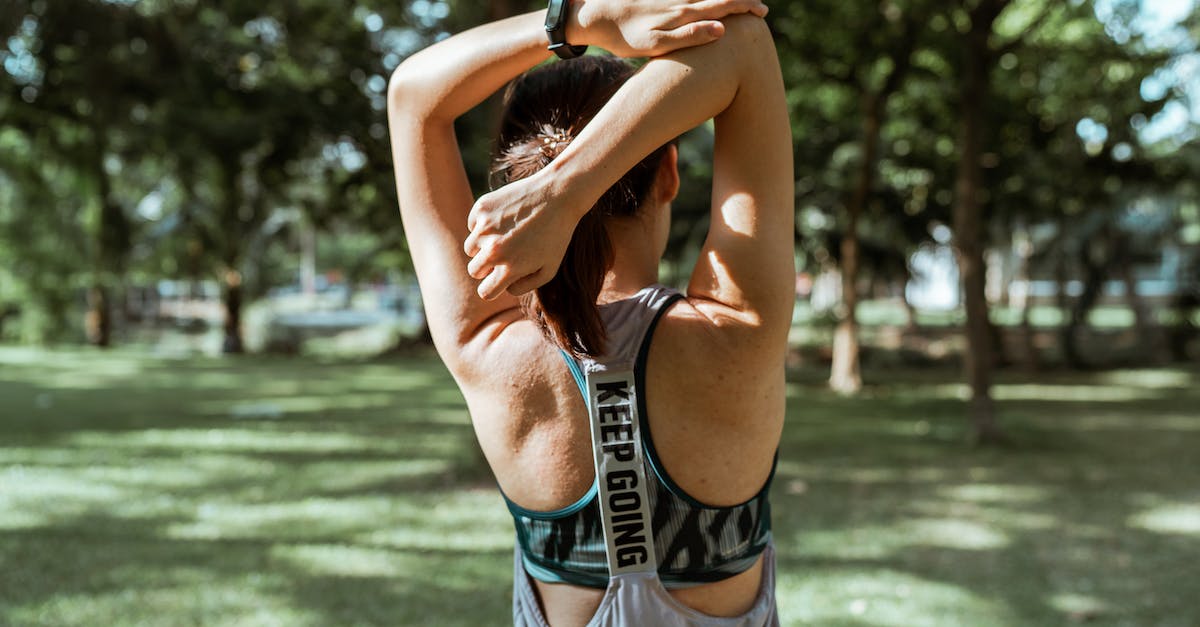 Getting back in the waste exchange in batman arkham city. - Unrecognizable female athlete stretching muscles of arms and back