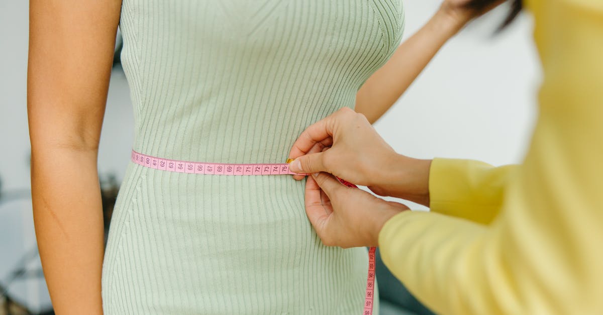 Getting More Health - Woman in White and Pink Stripe Dress Holding Pink Strap