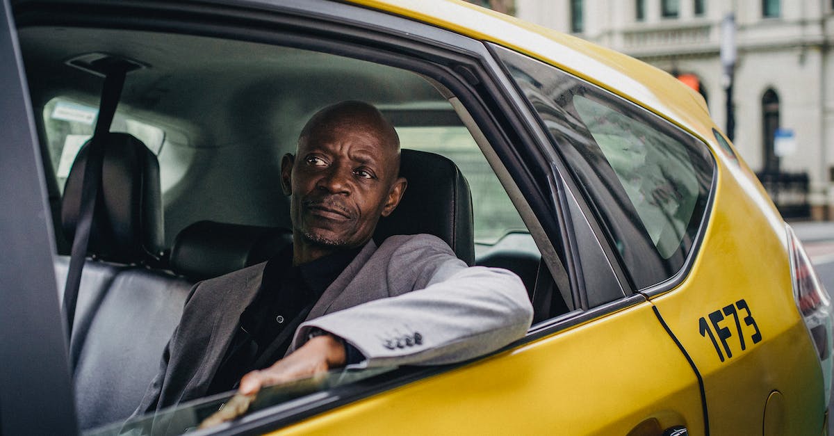Getting the most experience out of a taxi - Middle aged African American male in business suit looking away while going by taxi