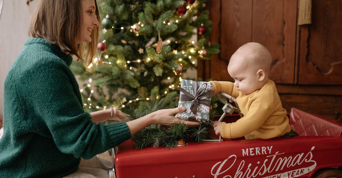 Give Baby Items - A Mother Giving a Present to a Baby Give Baby Items - A Mother Giving a Present to a Baby