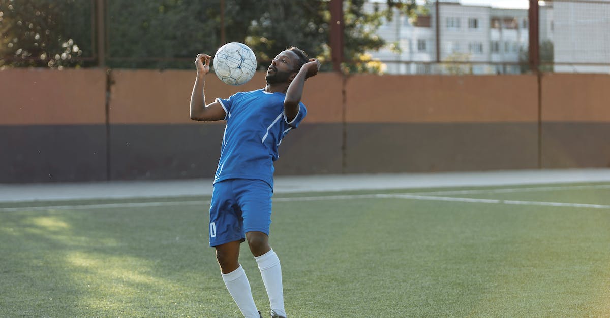 Giving player extra hearts - Man in Blue Jersey Shirt and Shorts Playing Soccer