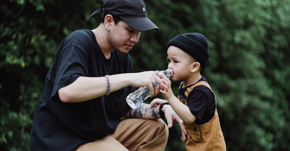 Giving water to strangers - Mother Giving Water to Child Giving water to strangers - Mother Giving Water to Child