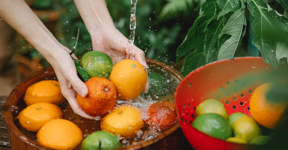 Granny Rags, Slackjaw, and Clean Hands - Woman washing fresh fruits in tropical orchard Granny Rags, Slackjaw, and Clean Hands - Woman washing fresh fruits in tropical orchard