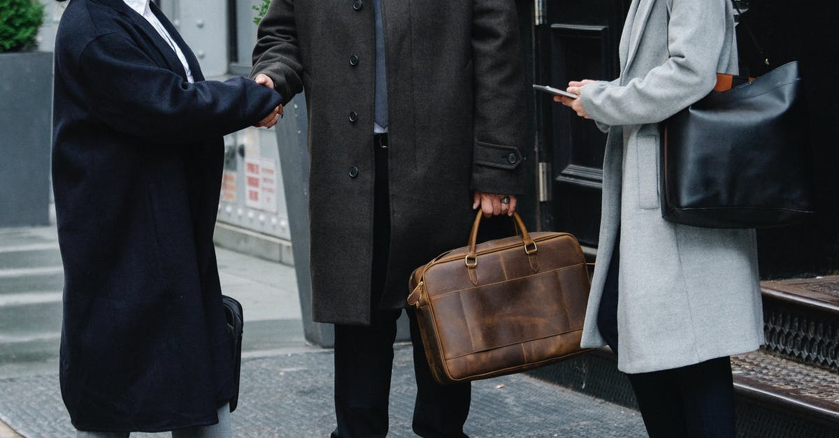 Group progress for Elite Dungeons - Crop anonymous trendy businessman and businesswomen in elegant outerwear shaking hands on street Group progress for Elite Dungeons - Crop anonymous trendy businessman and businesswomen in elegant outerwear shaking hands on street
