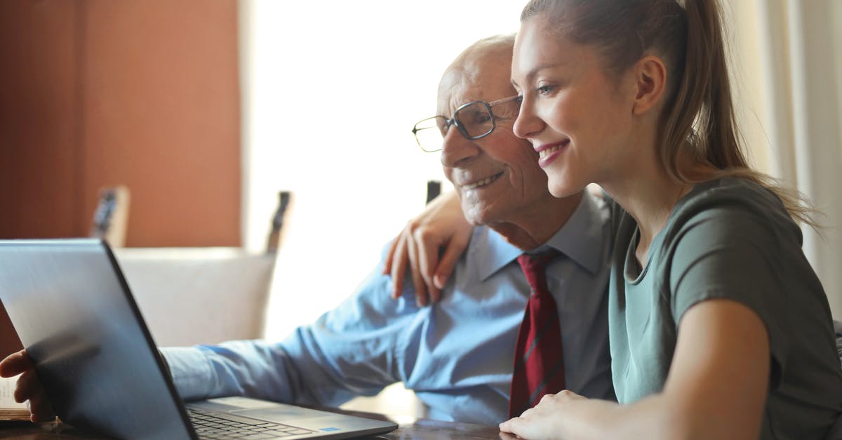 GroupManager/Essentials: No users can use the /help command - Young positive woman helping senior man using laptop GroupManager/Essentials: No users can use the /help command - Young positive woman helping senior man using laptop