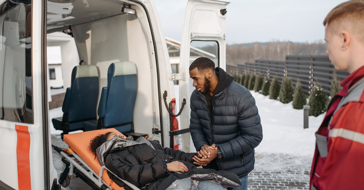 Gwent Chain Medic Revives? - Man in Black Jacket Sitting on White and Orange Car Gwent Chain Medic Revives? - Man in Black Jacket Sitting on White and Orange Car