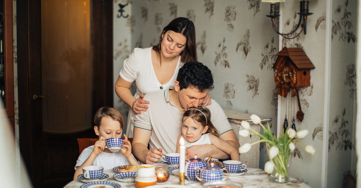 Had several rare pokemon run away while wife and son catch them - Cheerful family drinking tea at home Had several rare pokemon run away while wife and son catch them - Cheerful family drinking tea at home