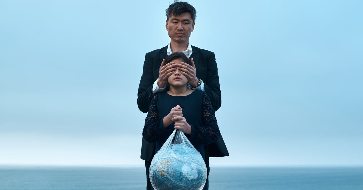 Half Life symbol on Portal.exe? [closed] - Asian male in formal wear standing near seashore and covering eyes of girl in black dress with Earth globe in plastic bag environment pollution concept